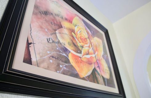 a picture of a yellow rose in a black frame with the words Yellow Rose of Texas